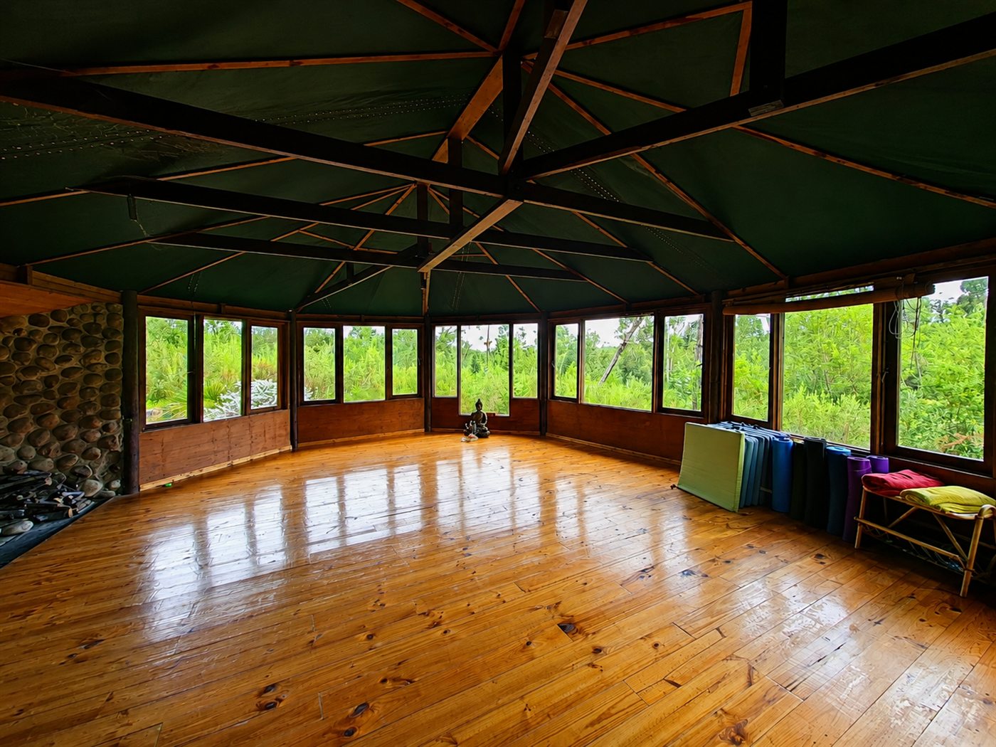Inside the wooden studio in the forest, windows on every side